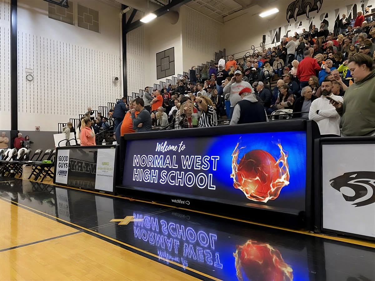 LED sponsor board courtside in a packed high school gym